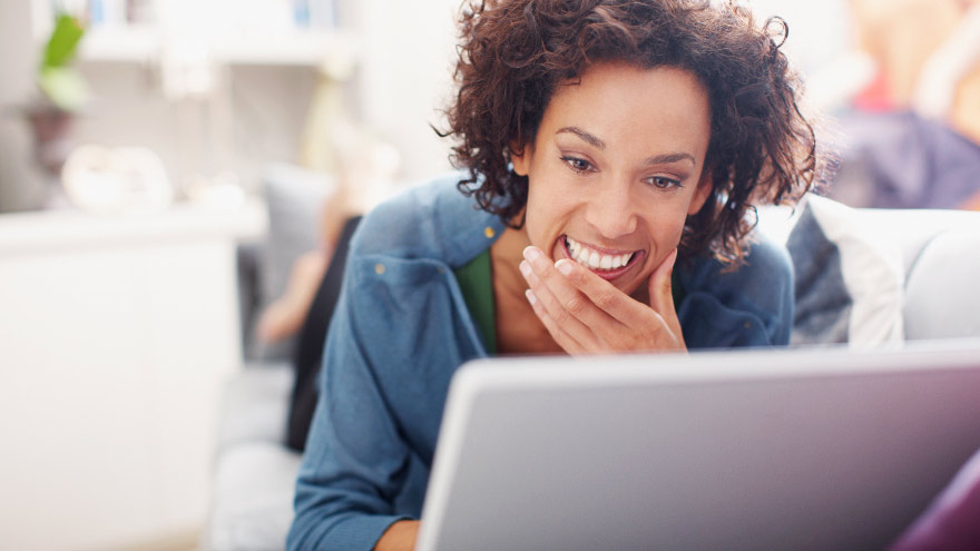 Young woman on computer subscribing to Dermatology eNews